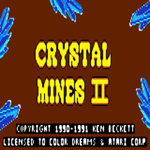Pantalla de títol de Crystal Mines II amb lletres grogues, cristalls blaus i crèdits a Ken Beckett.