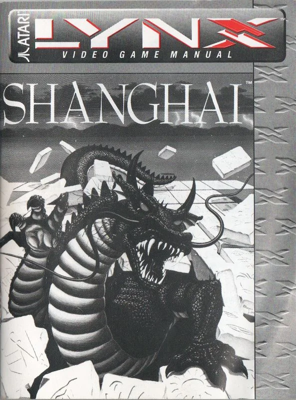 Portada monocroma del manual de Shanghai per a l’Atari Lynx, amb el drac envoltat de fitxes.