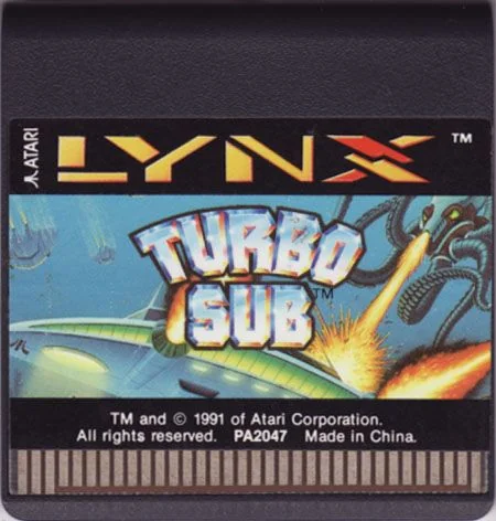 Targeta nord-americana de Turbo Sub per a Lynx amb il·lustració submarina, copyright de 1991, codi PA2047 i contactes visibles.