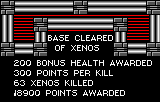 Pantalla de resultats amb BASE CLEARED OF XENOS, 63 enemics eliminats i 8900 punts concedits.