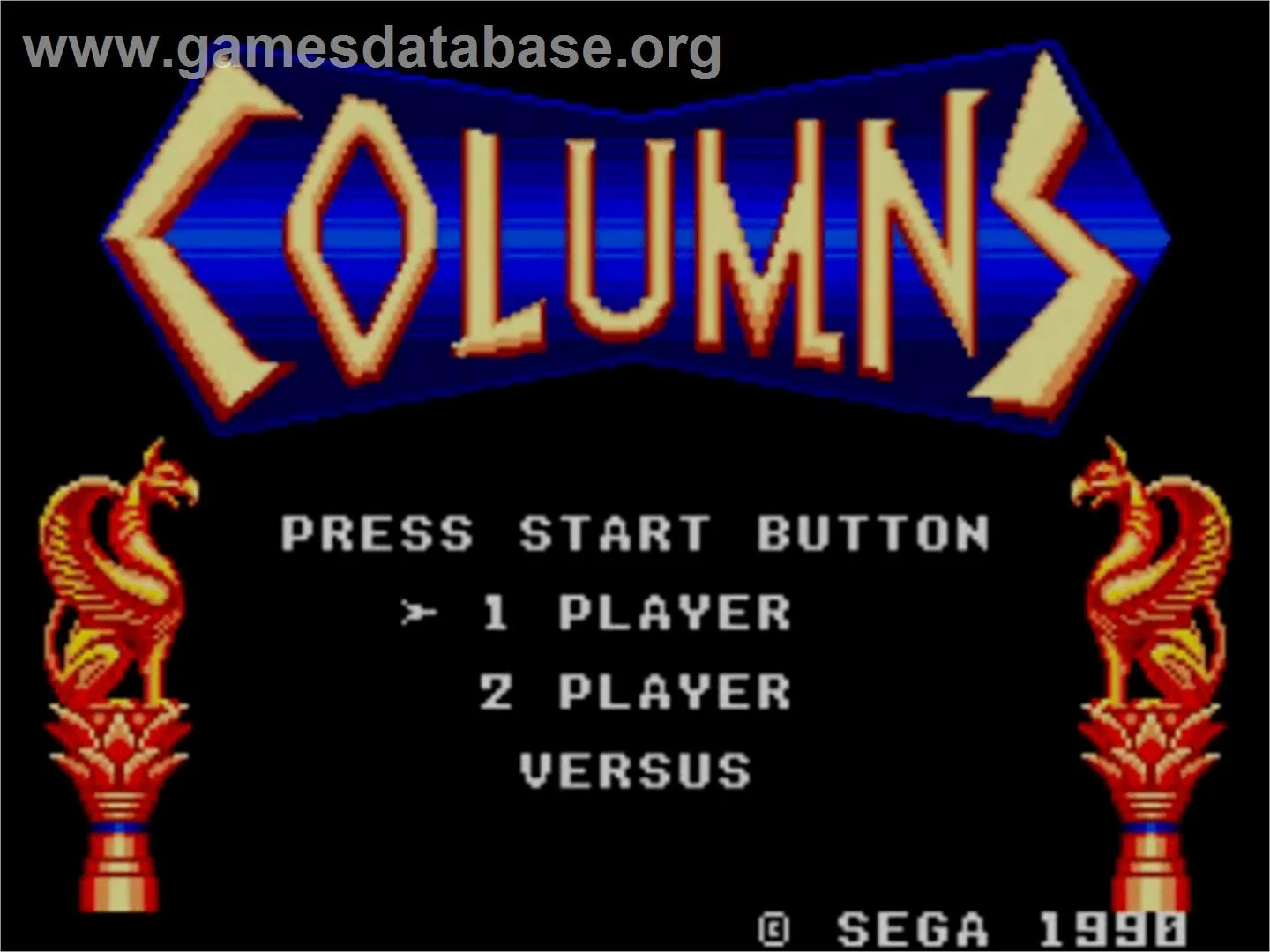 Pantalla de títol de Columns amb les opcions 1 Player, 2 Players i Versus entre figures ornamentals.