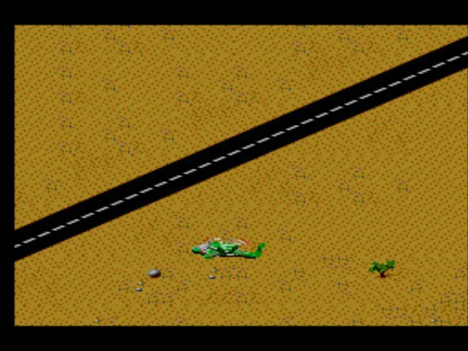 Helicòpter de Desert Strike volant al costat d’una carretera sobre el terreny isomètric.