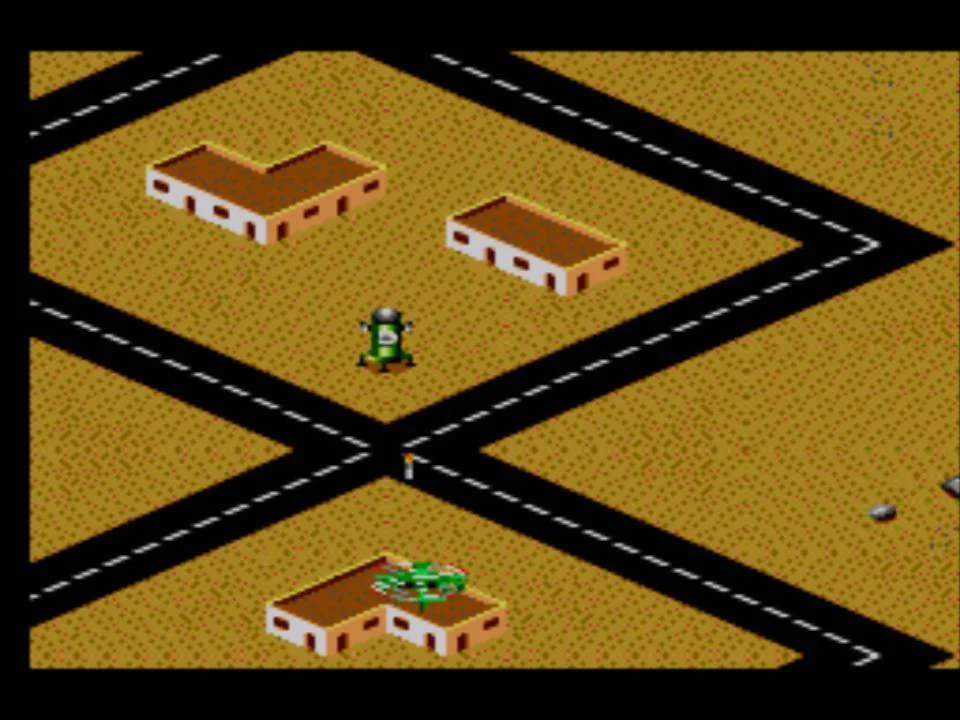 Helicòpter de Desert Strike sobre edificis, carreteres i una instal·lació cilíndrica en la conversió de Master System.