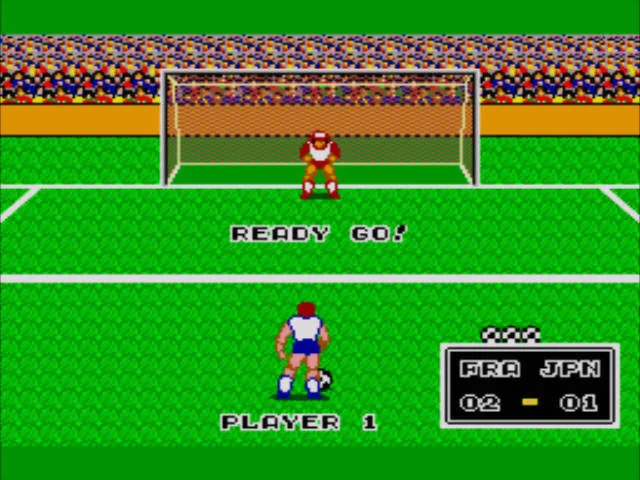 Preparació d'un penal a Great Soccer amb el llançador d'esquena, la porteria al fons i el marcador FRA-JPN.