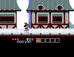Mickey avança per un poble mentre el marcador d’estat ocupa la franja inferior.