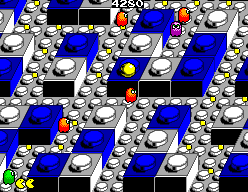 Pac-Man salta prop d’un fantasma vermell en un laberint blau i blanc.