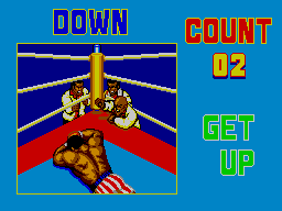Un boxador jeu a la lona mentre l’àrbitre fa el compte i la pantalla mostra les ordres DOWN i GET UP.