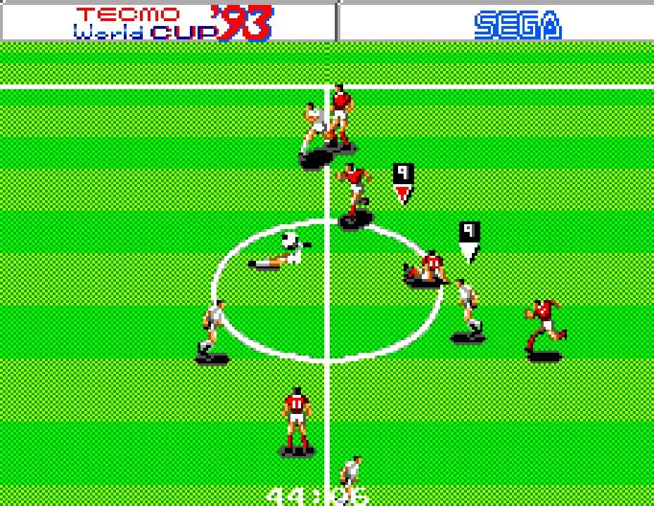 Partit de Tecmo World Cup '93 al mig del camp, amb jugadors vermells i blancs disputant la pilota.