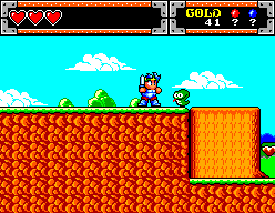 Shion salta entre petites criatures verdes davant d’una cascada en l’edició de Master System.
